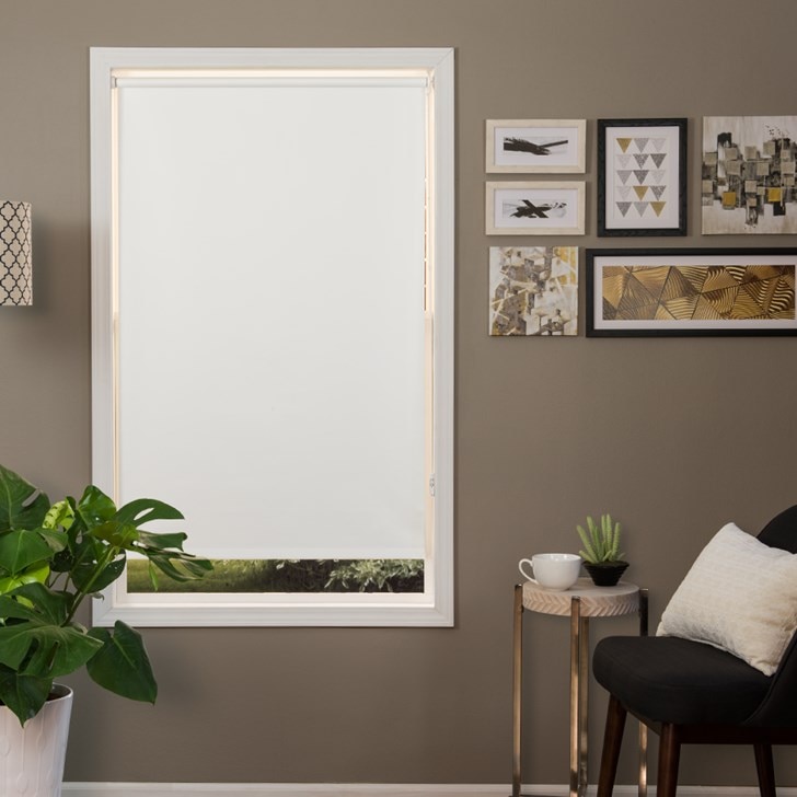 Room darkening roller shade in the color option Reminiscent White with the cordless spring tension lift control